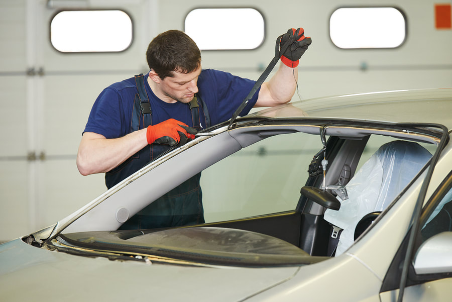 man installing the windshield